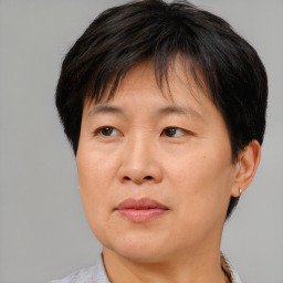 Joyful asian adult female with short  brown hair and brown eyes