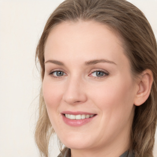 Joyful white young-adult female with long  brown hair and grey eyes