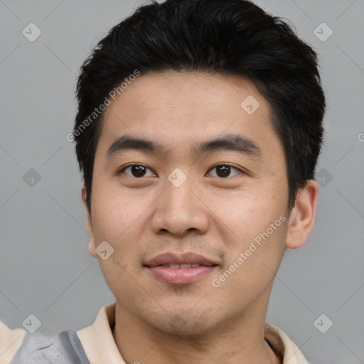 Joyful asian young-adult male with short  black hair and brown eyes