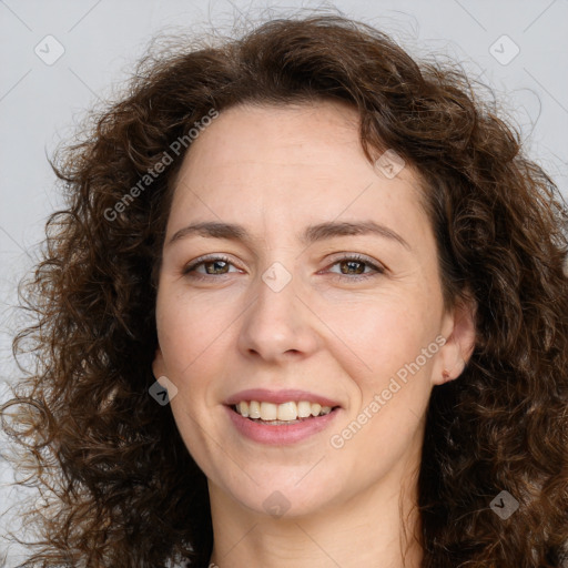 Joyful white adult female with long  brown hair and brown eyes