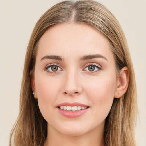 Joyful white young-adult female with long  brown hair and green eyes