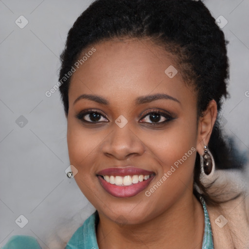 Joyful black young-adult female with long  black hair and brown eyes