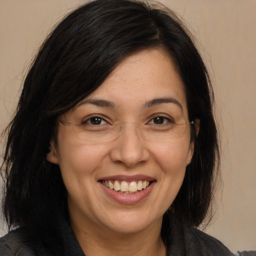 Joyful white adult female with medium  brown hair and brown eyes