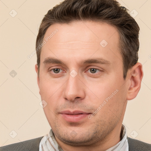 Joyful white young-adult male with short  brown hair and brown eyes