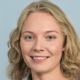 Joyful white young-adult female with medium  brown hair and green eyes