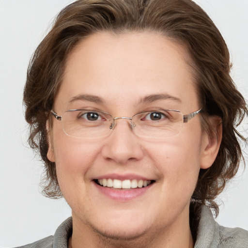 Joyful white adult female with medium  brown hair and grey eyes