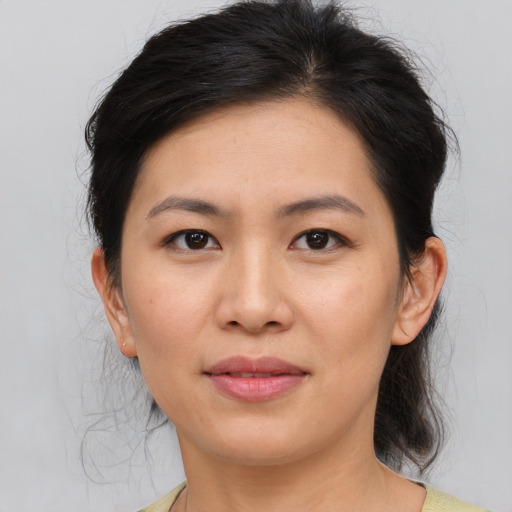 Joyful asian young-adult female with medium  brown hair and brown eyes