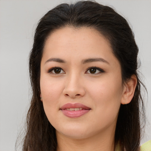 Joyful white young-adult female with long  brown hair and brown eyes