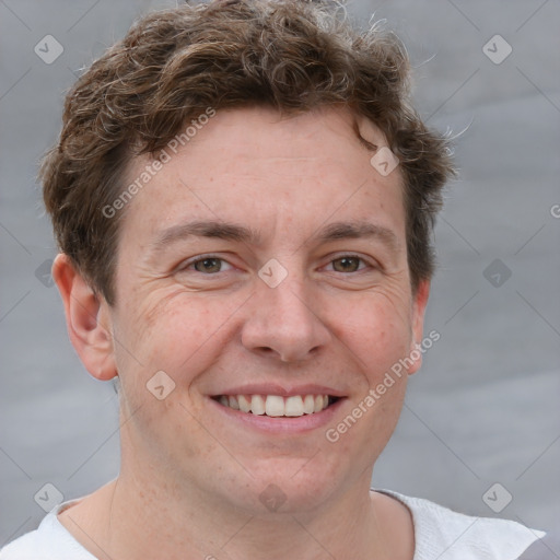 Joyful white adult male with short  brown hair and grey eyes