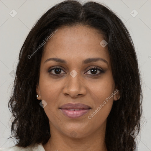 Joyful black young-adult female with long  brown hair and brown eyes