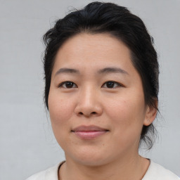 Joyful asian young-adult female with medium  brown hair and brown eyes