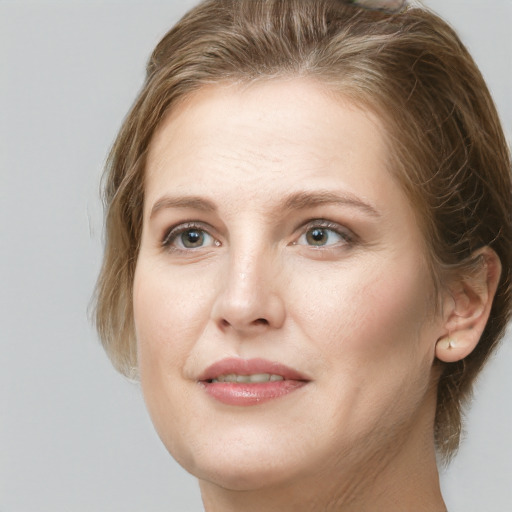 Joyful white young-adult female with medium  brown hair and grey eyes