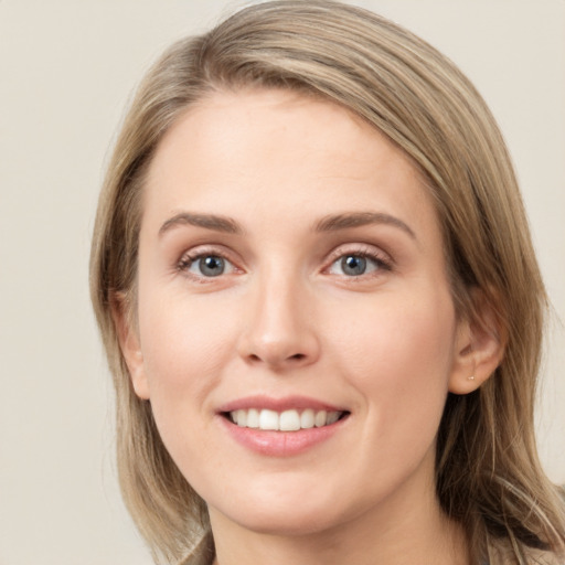 Joyful white young-adult female with long  brown hair and green eyes