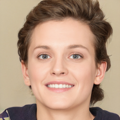 Joyful white young-adult female with medium  brown hair and green eyes