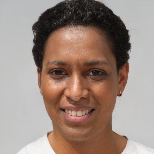 Joyful black adult female with short  brown hair and brown eyes