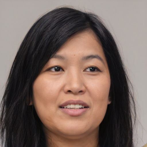 Joyful asian young-adult female with long  brown hair and brown eyes