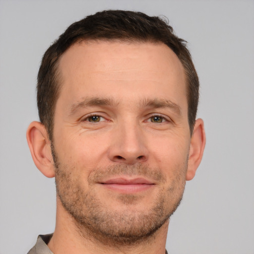 Joyful white adult male with short  brown hair and brown eyes