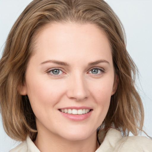 Joyful white young-adult female with medium  brown hair and blue eyes