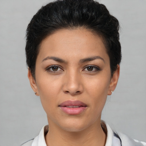 Joyful latino young-adult female with short  black hair and brown eyes