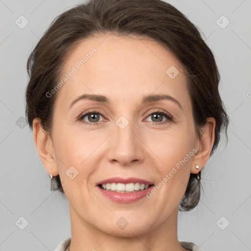 Joyful white adult female with medium  brown hair and grey eyes