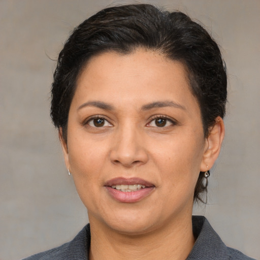 Joyful white adult female with medium  brown hair and brown eyes