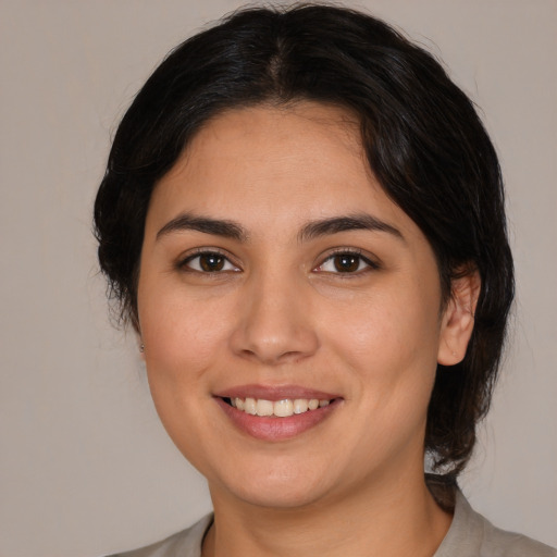 Joyful white young-adult female with medium  brown hair and brown eyes