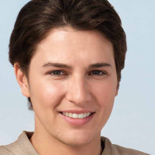 Joyful white young-adult female with short  brown hair and grey eyes