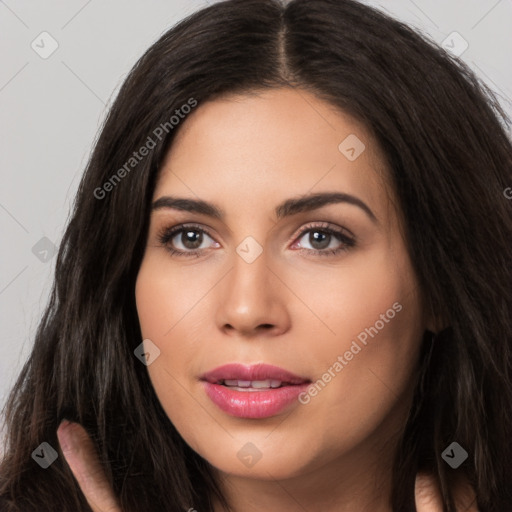 Joyful white young-adult female with long  black hair and brown eyes