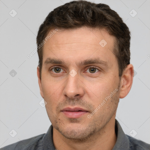 Joyful white adult male with short  brown hair and brown eyes