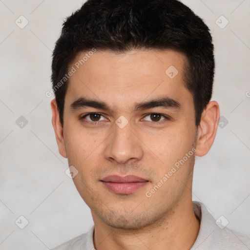 Joyful white young-adult male with short  black hair and brown eyes