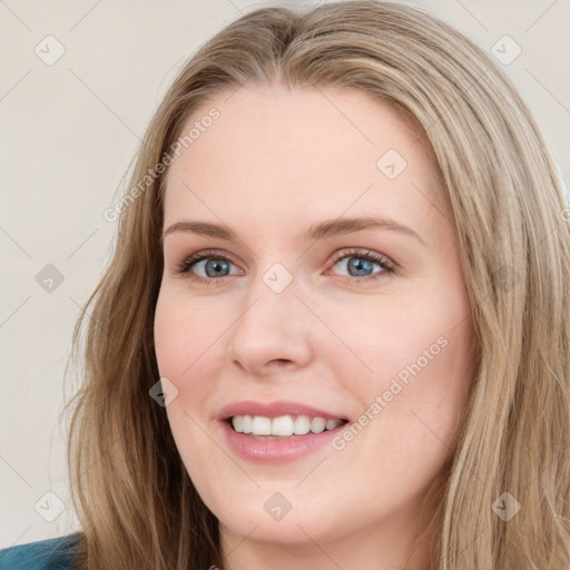 Joyful white young-adult female with long  brown hair and blue eyes