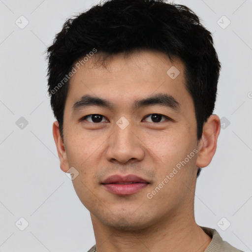 Joyful asian young-adult male with short  black hair and brown eyes