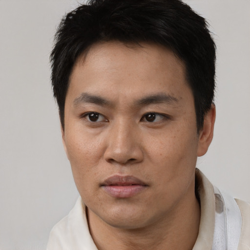 Neutral white young-adult male with short  black hair and brown eyes