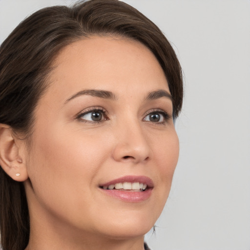 Joyful white young-adult female with medium  brown hair and brown eyes