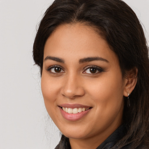 Joyful latino young-adult female with long  brown hair and brown eyes