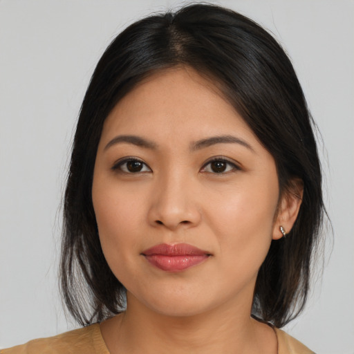 Joyful latino young-adult female with medium  brown hair and brown eyes