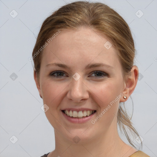 Joyful white young-adult female with medium  brown hair and grey eyes