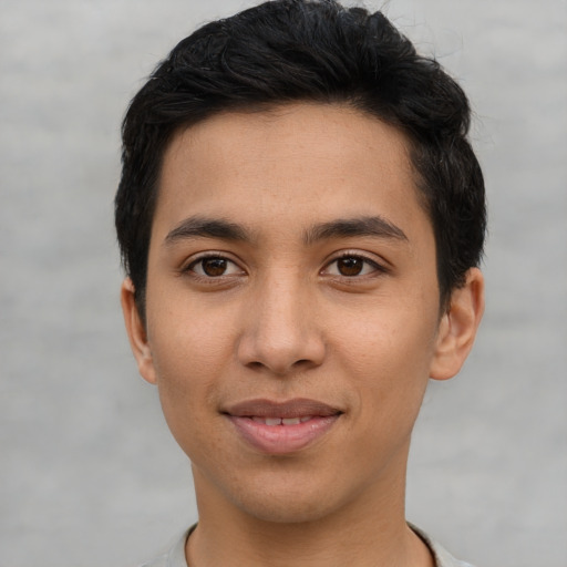 Joyful asian young-adult male with short  black hair and brown eyes