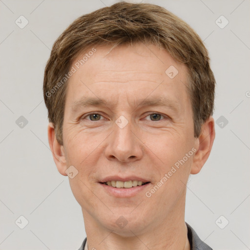 Joyful white adult male with short  brown hair and grey eyes