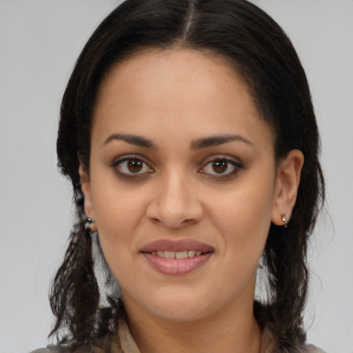 Joyful latino young-adult female with medium  brown hair and brown eyes