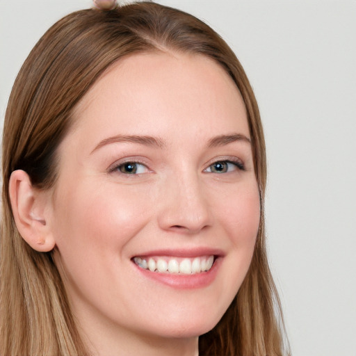 Joyful white young-adult female with long  brown hair and grey eyes