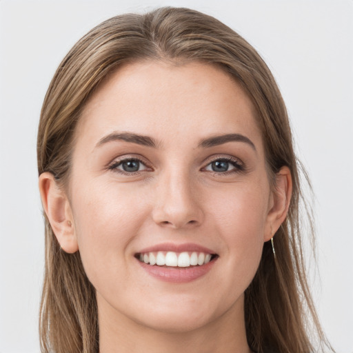 Joyful white young-adult female with long  brown hair and grey eyes