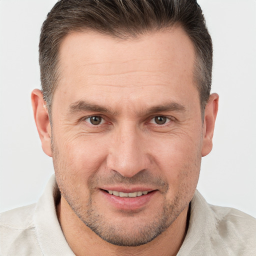 Joyful white adult male with short  brown hair and brown eyes