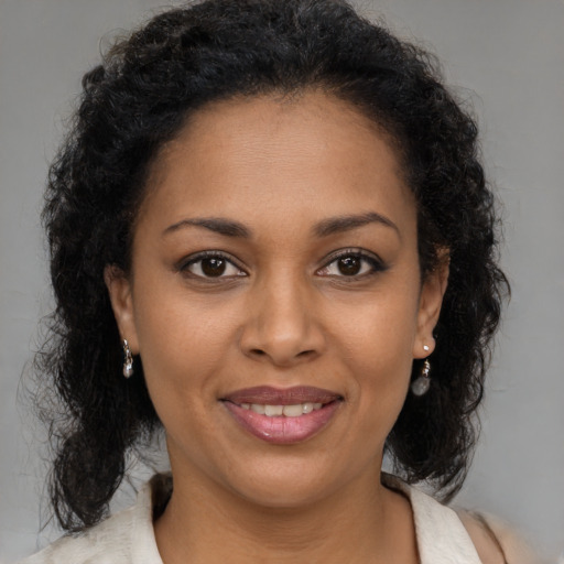 Joyful black young-adult female with medium  brown hair and brown eyes