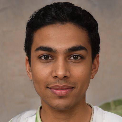 Joyful latino young-adult male with short  black hair and brown eyes