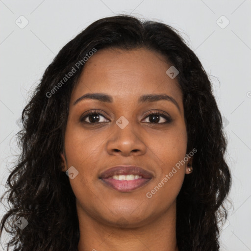 Joyful black young-adult female with long  brown hair and brown eyes