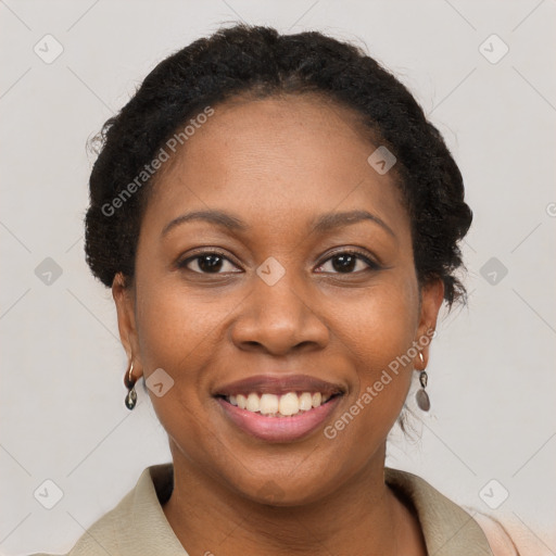 Joyful black young-adult female with short  brown hair and brown eyes