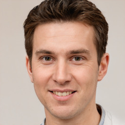 Joyful white adult male with short  brown hair and brown eyes