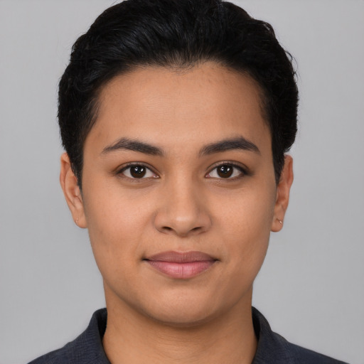 Joyful latino young-adult female with short  black hair and brown eyes