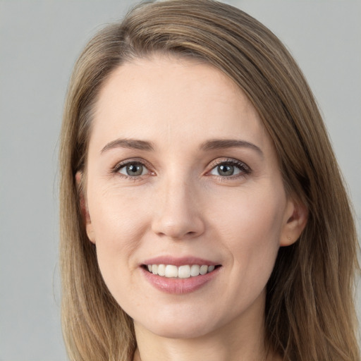 Joyful white young-adult female with long  brown hair and grey eyes